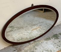 An oval mahogany framed hall mirror 72cm x 44cm