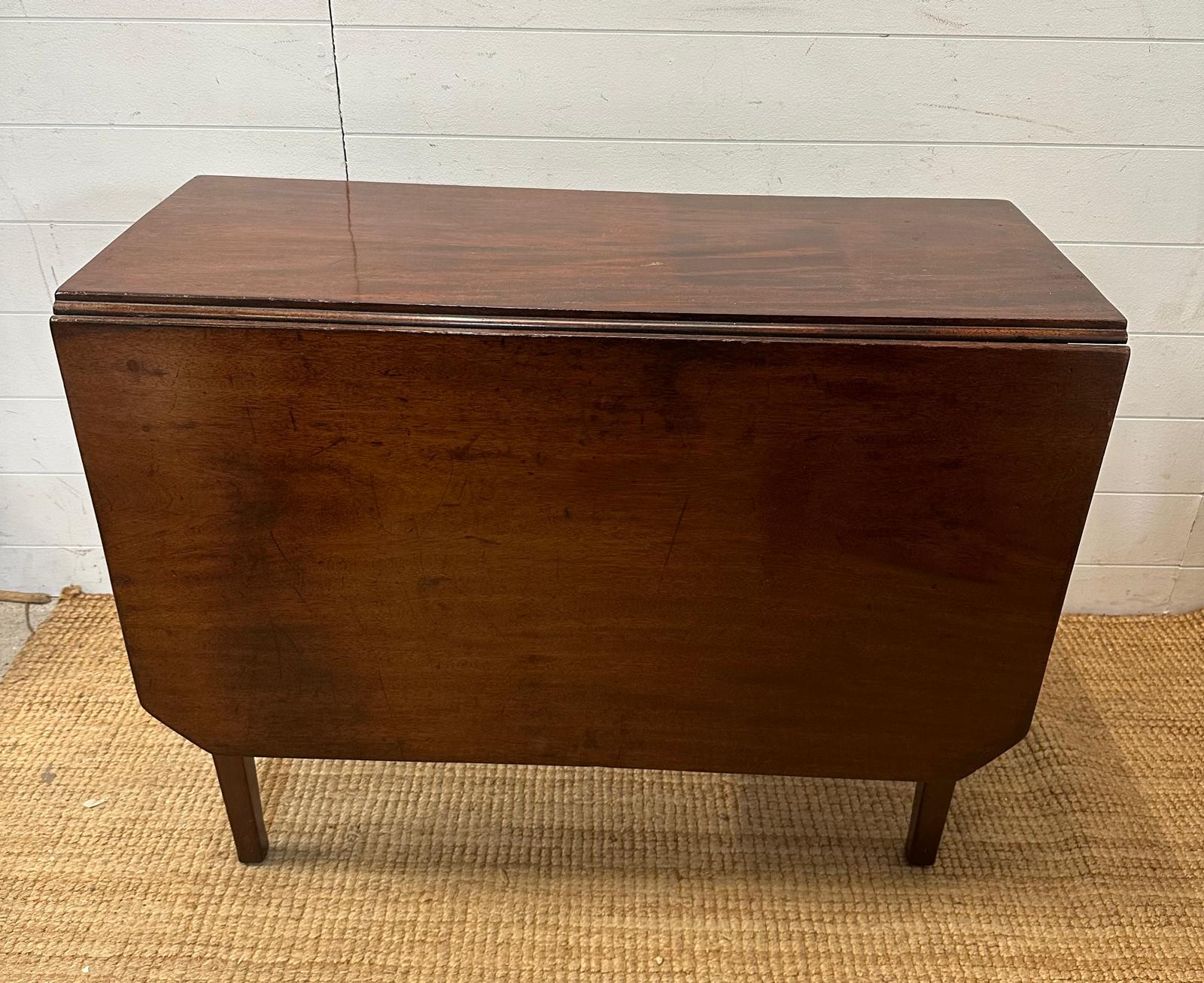 A mahogany gateleg table on tapering legs (D91cm W126cm H72cm)