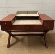 A brown leather campaign style writing desk, one long central drawer flanked by two shorter drawers,