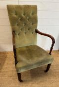 A Victorian mahogany framed arm chair on castors and upholstered in a pale green