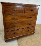 A mahogany chest of drawers with knob handles (H124cm W119cm D52cm)
