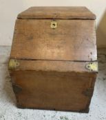 A vintage pine campaign style storage box with two hinged lids, brass fittings and laundry to