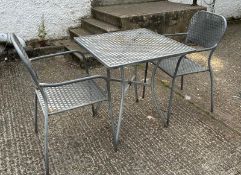A metal starburst garden table and two chairs (H73cm SQ70cm)