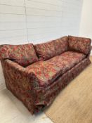 A red paisley upholstered corner sofa