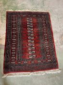 A rug with red grounds and geometric design 136cm x 98cm