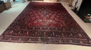An Iranian Persian Heriz rug with blue boarder and distinct centre medallion 100% wool 317cm x 420cm