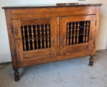 An 18th century fruitwood/walnut Welsh food cupboard with spindle front on turned legs and a