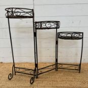 A three tier wrought iron foldable plant stand