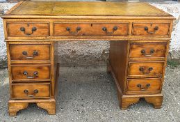 A green leather topped pedestal desk (H79cm W120cm D60cm)