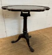 A Chippendale style mahogany tilt topped bird cage table, tripod legs ending in claw and ball