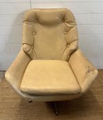 A Mid Century cream faux leather swivel lounge chair, button backed and on splayed chrome feet AF