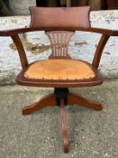 An oak revolving desk chair
