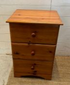 A pine three drawer bedside (H67cm SQ48cm)