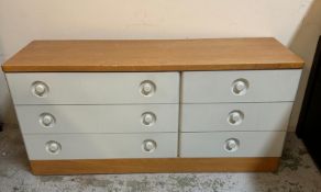 A grey pine topped chest of drawers by Stag comprising of three long drawers and two adjacent