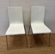 Two white Italian Sintesi chairs on chrome legs