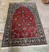 A rug with red grounds, blue boarder and birds of paradise 206cm x 132cm