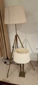 A brass tripod floor lamp and a pair of brass table lamps