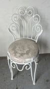A scrolling wrought iron bedroom chair