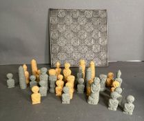 A carved stone chess set and board