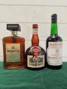 A bottle of Disaronno, a bottle of Harveys Bristol Cream and a bottle of Grand Marnier