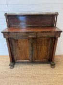 A Victorian chiffonnier with brass gallery top panelled doors and turned supports (H100cm W102cm