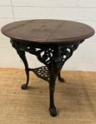 A vintage black painted circular cast iron pub table with a wooden top (H75cm Dia68cm)