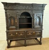 A heavily carved court cabinet on stand