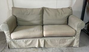 A two seater sofa bed with removable covers and two matching arm chairs
