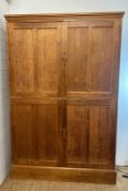 A large arts and crafts pine kitchen storage cupboard, two over two door cupboards with a total of