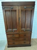 An Arts and Crafts style oak linen press, the cupboard opening to four drawers over two short and