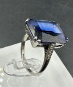 A platinum and 18ct white gold ring with diamond shoulders. Approximate size M