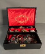 A jewellery box with a variety of costume jewellery.