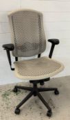 An ergonomic desk chair in grey on castors