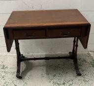 A drop sided side table on lion paw feet (H53cm W64cm D40cm)