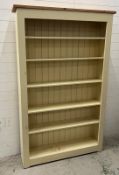 A large painted open bookcase with six shelves and panelled back (H200cm W126cm D25cm)