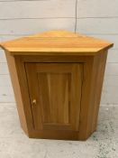 An oak corner unit opening to shelves (H78cm W71cm D45cm)