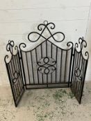 A wrought iron fire screen H90cm