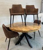 A wooden circular dining table on black wrought iron X frame legs by Label 31 and four