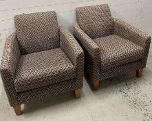A pair of club chairs upholstered in charcoal
