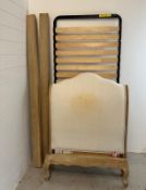 A French style single bed with a white upholstered bed head by Loaf