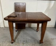 An oak Arts and Crafts style extendable dining table. Wind out mechanism and extra leaf (D102cm