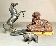 A selection of ornamental animals, a prancing horse, a reclining dog and a bear