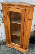A pine corner unit with glazed front (H107cm W64cm D38cm)