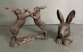 A pair of boxing hares and a bust of a hare