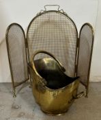 A brass fire guard and coal scuttle