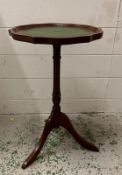 A green leather topped wine table. Height 51cm