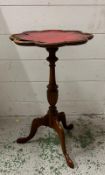 A red leather topped wine table Height 51cm AF