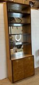 A contemporary mirror back bookcase with four shelves and a two drawer cupboard under (H244cm