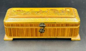 A vintage wooden scent bottle box with four small scent bottles