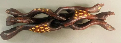 An Indian carved tripod stand with inlay.